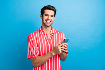 Photo of excited cheerful man dressed striped shirt chatting instagram twitter telegram facebook...