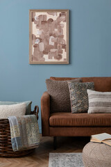 Creative composition of rural style living room interior with brown sofa, pouf, mock up poster...