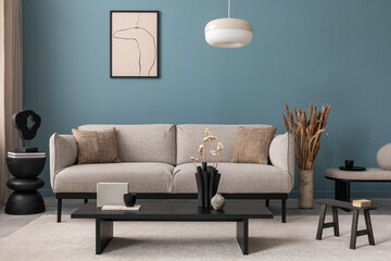 Creative composition of living room interior with mock up poster frame, grey sofa, black coffee table, blue wall, stylish furnitures, decorations and personal accessories. Template. Home decor.	
