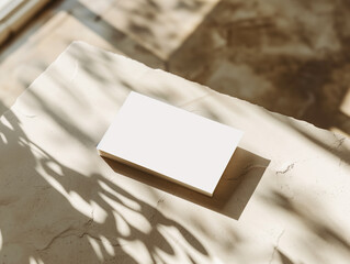 white blank business card mockup on the table, light shadow