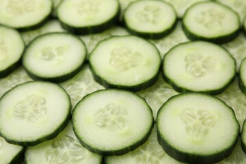Fresh slices of cucumbers as background, closeup