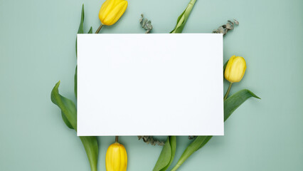 Empty white paper blank, flowers on green background. Wedding branding mock up. Top view. Copy space