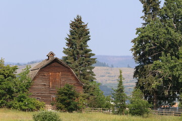Farmhouse barn standing in rural British Columbia on a sunny day