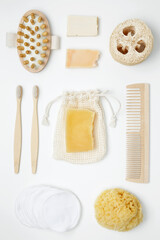 Natural organic eco cosmetics. Soap Eco, reusable cotton pads, loofah natural sponge washcloth, cotton swab, eucalyptus leaves on white background. Flat lay, top view