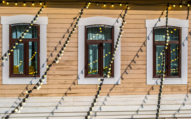 The wall of the house is made of wood with a window.