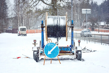 Wooden coil with  fiber optic cable mounted on trailer for easy transportation. Laying optical...