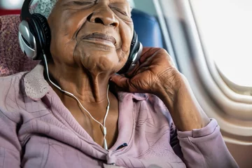 Foto op Plexiglas Oud vliegtuig old woman sleeping, grandmother sleeps, elderly person asleep, woman with headset, person sitting in a plane, black senior female