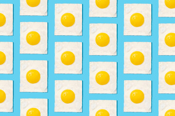 Egg pattern on blue background. Creative food concept, morning breakfast brunch concept. Modern minimal food photography collage
