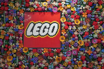 Fototapeta premium A display of Lego flowers at their retail store in London, with the company logo in the center which is also made of bricks.