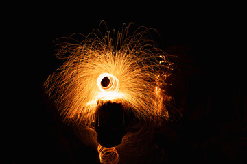Abstract background of steel wool fireworks on Hat Chom Dao at after twilight blue hour, Showers of...