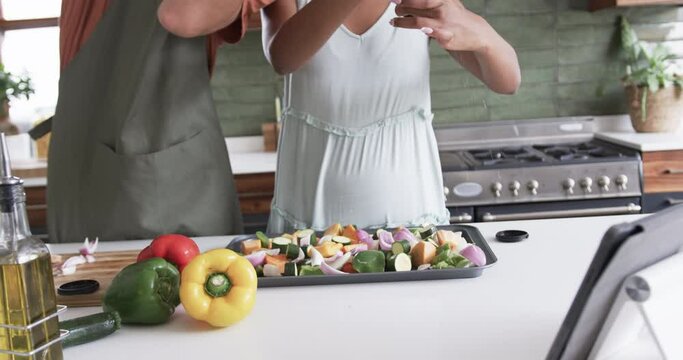 Diverse couple prepares a meal in a home kitchen