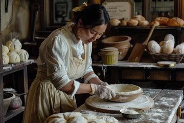Foto op Canvas A Women preparing dough in bakery kitchen © Kien