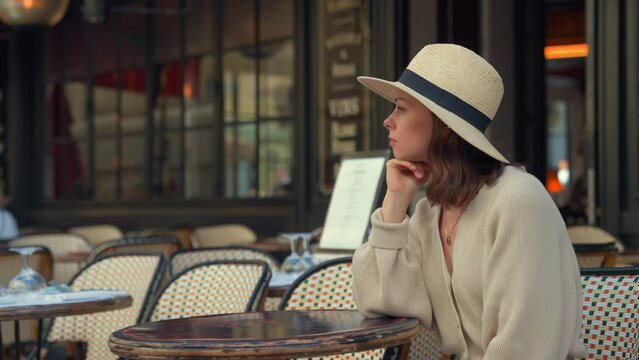 Pensive Moment at a Parisian Cafe