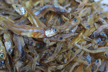 Background texture of dried anchovy fish, uncooked. Preserved with salt