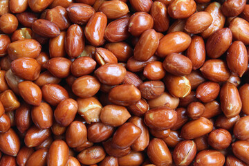 Background texture of fried groundnut, Goober or Monkey Nut, or Arachis hypogaea. Flat lay or top view