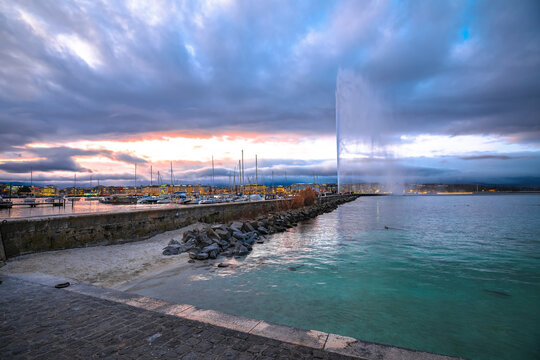 City of Geneva Lac Leman waterfront and Jet d Eau fountain sunset view