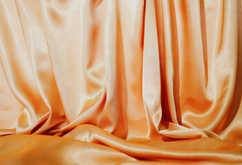 BackdropYellow silk satin  Drape fabric Gold color Luxurious background. Beautiful wavy area for...