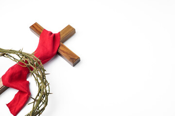 Jesus Wooden cross wrapped with red cloth and Crown of Thorns used by Catholic Christians on Good Friday Ceremony. Isolated on white background with empty blank copy text space. - obrazy, fototapety, plakaty