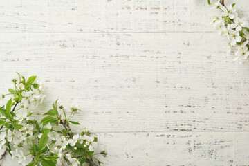 Spring background with white apple or cherry blossoms and wooden background. Easter or Passover...