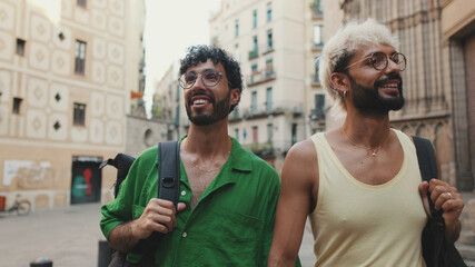 homosexual couple exploring streets of old city enjoying summer vacation together