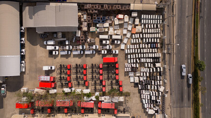 Top view of the electric vehicle transport yard and intercontinental shipping industry. - obrazy, fototapety, plakaty