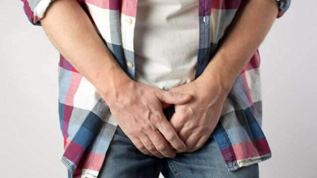 Man Pee His Pants, close-up.  A man suffering from pain in the pelvic organs