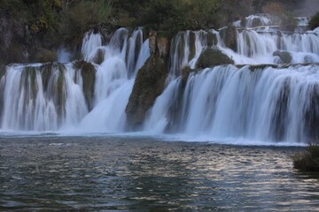 Picturesque view of beautiful waterfall and rocks outdoors