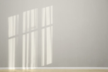 Light and shadows from window on wall indoors