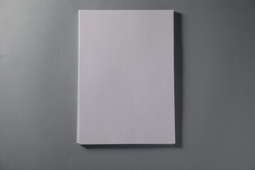 Stack of blank paper sheets on grey background, top view. Space for text
