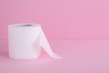 Soft toilet paper roll on pink background. Space for text