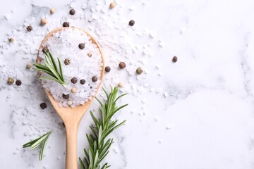 Salt with rosemary and peppercorns in spoon on white marble table, flat lay. Space for text