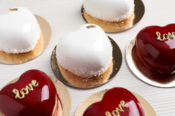 St. Valentine's Day. Delicious heart shaped cakes on white wooden table, closeup