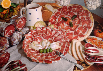 Detail of a table set with cured meats