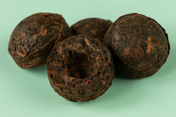 A pile of high quality fifteen years old pressed Pu Erh Mini Tou Cha tea. 