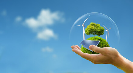 Fototapeta na wymiar Business hand holds green globe with tree, wind turbine and solar powered for ESG, CO2 and Net Zero concept for sustainable corporate environmental development. Save the environment. 