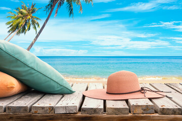Tropical beach with wide brim hat and pillow, relax at summer holiday background