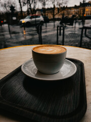 Close up of a light brown fresh mocha with beautiful latte art outdoors on a cafe in Paris