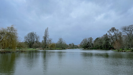 Fototapeta premium Romantic city park with beautiful lake in autumn sunny day. Daumesnil lake in Vincennes forest of Paris, France.