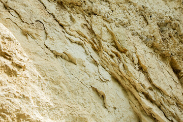Uneven, rough stone texture, retractable rock close-up. Natural background for design. Front view