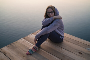 Woman sitting on the pier