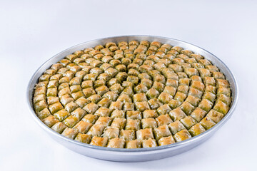 Top view of traditional Turkish dessert, sliced dry baklava with pistachio or walnut.