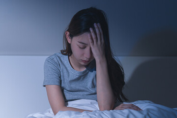 Sad worried and stressed, depressed asian young woman, girl suffering in bed from insomnia problem, awake at night, hand covering face from trouble disturbed loud noise, unable sleep. Restless people.