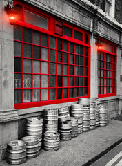 Dublin Street, Row of stacked beer kegs outside of a building.  The image shows a part of a traditional pub in Dublin showcasing its classic architectural design.