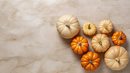 A group of pumpkins on a beige color marble
