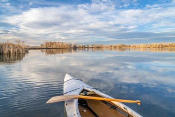 decked expedtion canoe on a calm lake in northern Colorado, winter scenery without snow