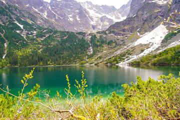 Morskie Oko mountain lake panorama  , clear water and rocky path
