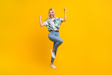 Full length photo of ecstatic girl dressed print blouse jeans shout yeah clenching fists win...