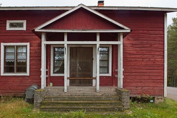 Entry way to traditionally red painted wood building.