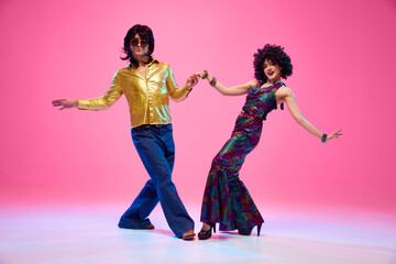 Disco Dreams. Dance duo, man and woman in retro fashion outfit dancing in motion against gradient...