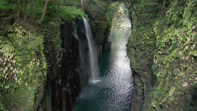 Takachiho Gorge (高千穂峡, Takachiho-kyō), a narrow chasm cut through the rock by the Gokase River waterfall in the forest